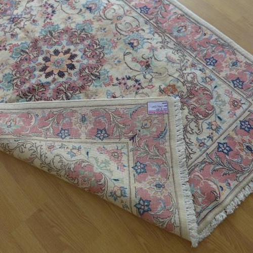 136 - A hand knotted woollen handmade Tabriz rug - 1.94m x 1.40m