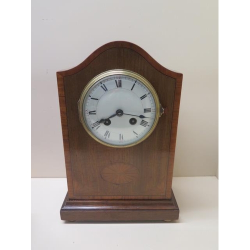 106 - An early 20th century mantle clock with 8 day movement, strikes on a bell in an inlaid walnut case -... 