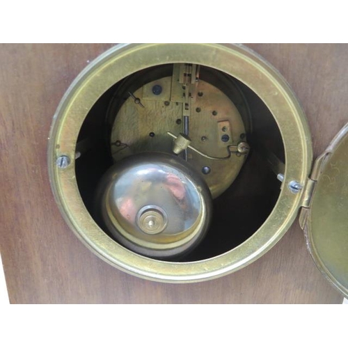 106 - An early 20th century mantle clock with 8 day movement, strikes on a bell in an inlaid walnut case -... 