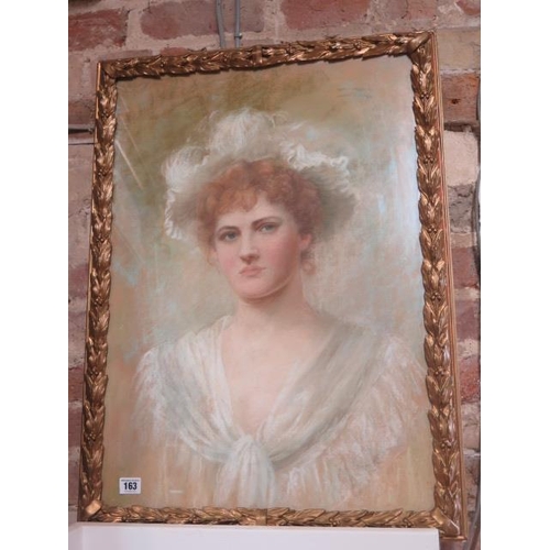 163 - A pastel portrait of a young lady in a gilt frame, signed indistinctly - frame size 74cm x 55cm