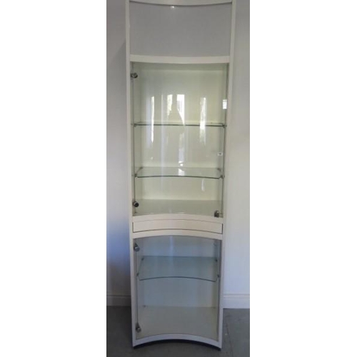 17 - A good jewellers shop cabinet with two concave glass doors with three adjustable shelves and a push ... 