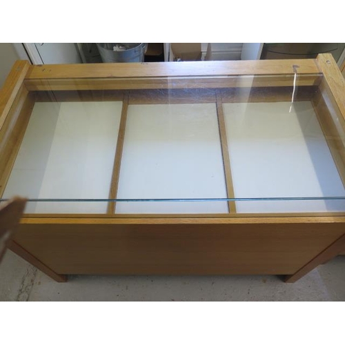 18 - A good quality jewellers shop cabinet with three sliding display drawers and three cupboard doors to... 