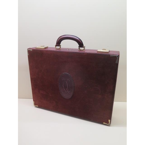 A vintage Les Must de CARTIER Paris burgundy leather and suede briefcase with clip locks and combina