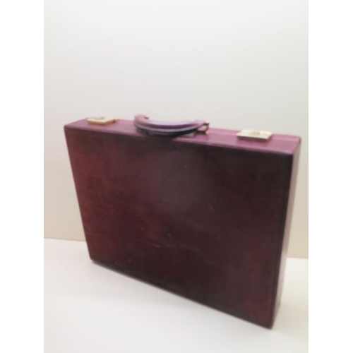 202 - A vintage Les Must de CARTIER Paris burgundy leather and suede briefcase with clip locks and combina... 