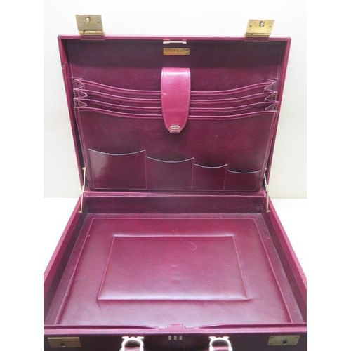 202 - A vintage Les Must de CARTIER Paris burgundy leather and suede briefcase with clip locks and combina... 