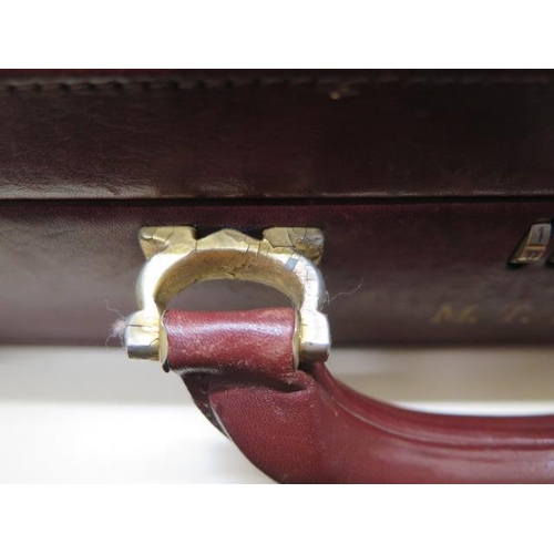 202 - A vintage Les Must de CARTIER Paris burgundy leather and suede briefcase with clip locks and combina... 