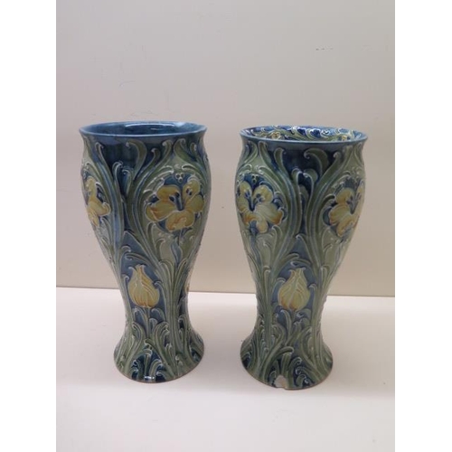 William Moorcroft green signature near pair of Florian type vases - Height 25cm - one has a chip to top rim, the other has crack and chip to top and chip to base, both have crazing