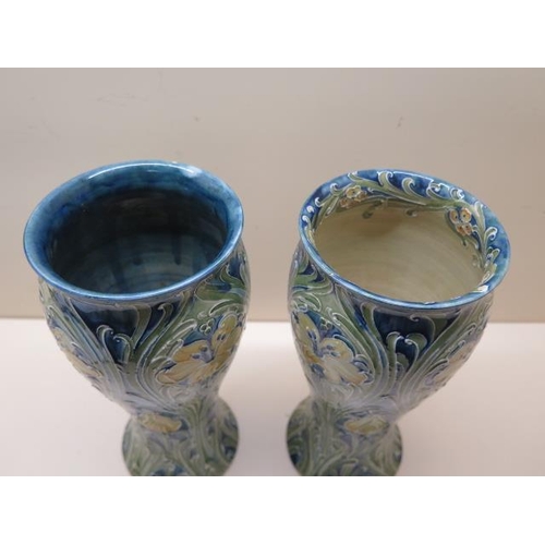 203 - William Moorcroft green signature near pair of Florian type vases - Height 25cm - one has a chip to ... 