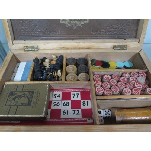 239 - An early 1900's/Edwardian games compendium in fitted pine case includes chess, draughts, dice, bingo... 