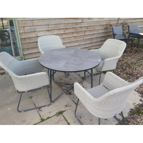 28 - A Bramblecrest all weather table - Diameter 108cm - and four chairs