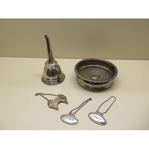 324 - A silver plated wine funnel, a plated decanter coaster and three plated decanter labels