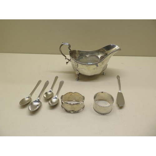 326 - A silver sauce boat, two silver napkin rings and four silver spoons and a knife - total approx weigh... 