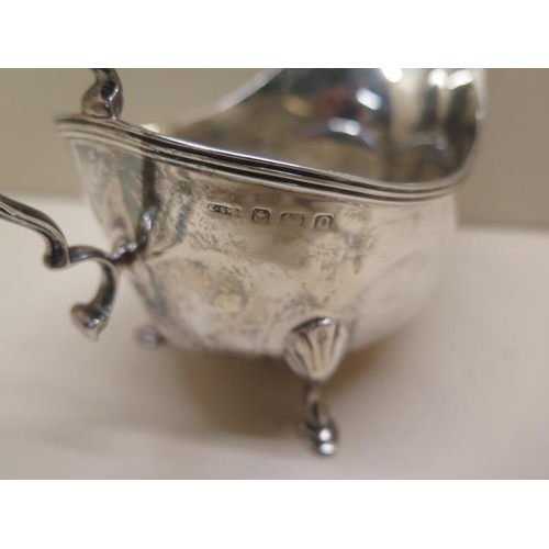 326 - A silver sauce boat, two silver napkin rings and four silver spoons and a knife - total approx weigh... 