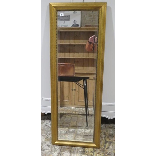 37 - A modern mirror with bevelled edged glass - 142cm x 50cm