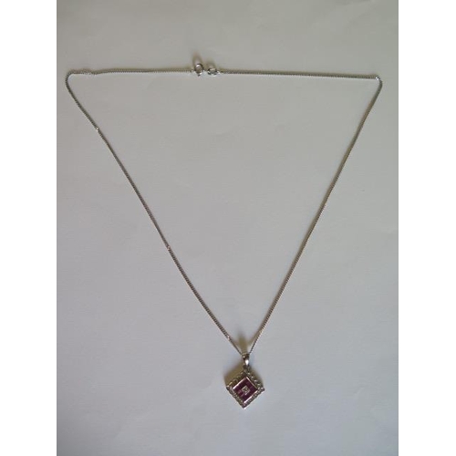 426 - An 18ct white gold ruby and diamond set pendant 12mm square on 47cm white gold chain - total approx ... 