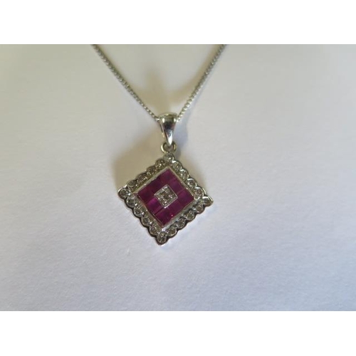 426 - An 18ct white gold ruby and diamond set pendant 12mm square on 47cm white gold chain - total approx ... 