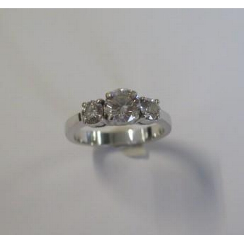 A good 18ct 750 white gold three stone diamond ring with a central 1.04ct diamond flanked by two smaller diamonds - total approx weight 0.54ct - clarity SI1, colour F - ring size M/N - approx weight 5.4 grams with E.G.L diamond report and an insurance valuation for £5,750 dated 2002 - in good overall condition some wear to shank
