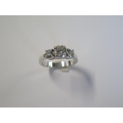 427 - A good 18ct 750 white gold three stone diamond ring with a central 1.04ct diamond flanked by two sma... 