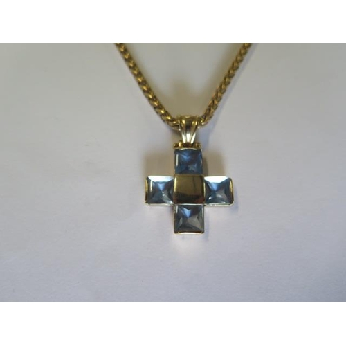 433 - A 9ct yellow gold blue stone cross on a 9ct yellow gold 46cm chain - total weight approx 14.3 grams