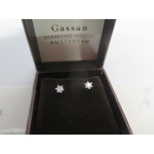 438 - A pair of 18ct white gold diamond stud earrings - each brilliant cut diamond approx 0.25ct with Gass... 