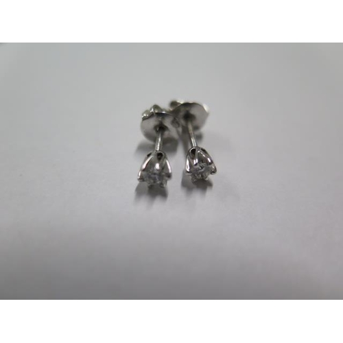 438 - A pair of 18ct white gold diamond stud earrings - each brilliant cut diamond approx 0.25ct with Gass... 