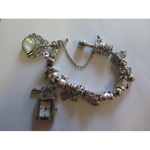 442 - A Pandora silver bracelet with assorted charms including 925 charm company and others - total weight... 