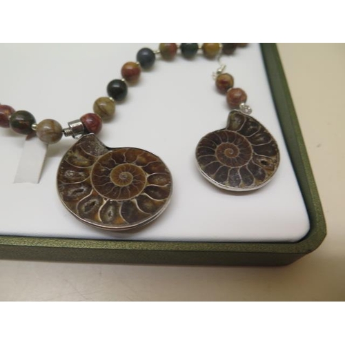 443 - A Jasper and Jurassic Fossil Ammonite necklace and earrings in a presentation box