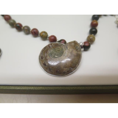 443 - A Jasper and Jurassic Fossil Ammonite necklace and earrings in a presentation box