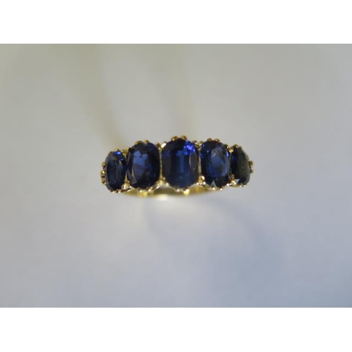 464 - An Edwardian 18ct yellow gold five stone sapphire ring - sapphires are well matched and a good colou... 