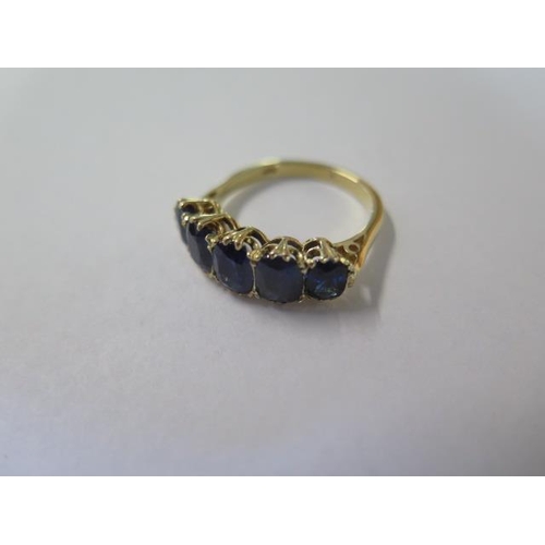 464 - An Edwardian 18ct yellow gold five stone sapphire ring - sapphires are well matched and a good colou... 