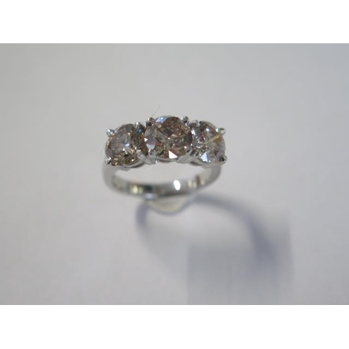 466 - An impressive platinum three stone diamond ring - total diamond weight 4.04ct made up of centre ston... 