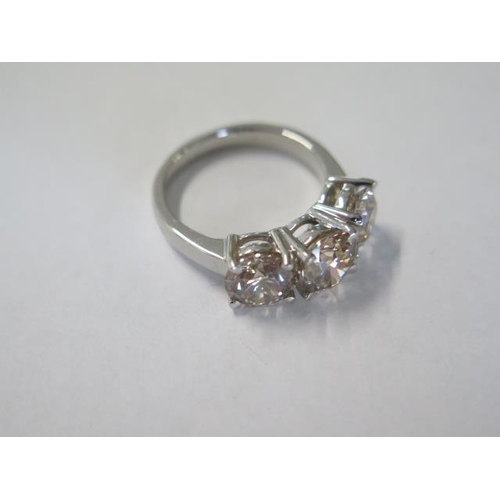 466 - An impressive platinum three stone diamond ring - total diamond weight 4.04ct made up of centre ston... 