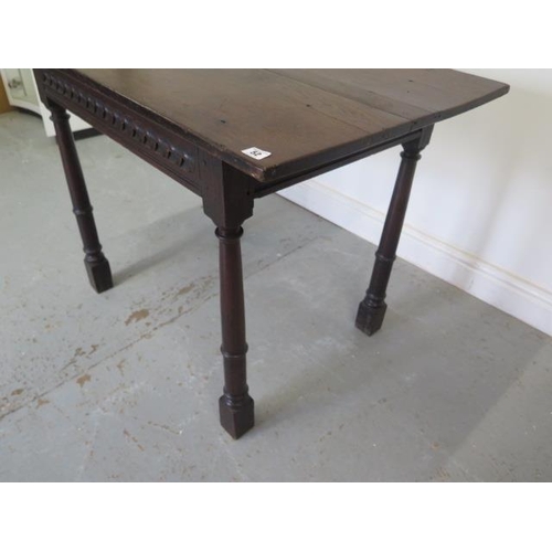 52 - An antique oak side table with a carved frieze and tapering turned supports - good colour and patina... 