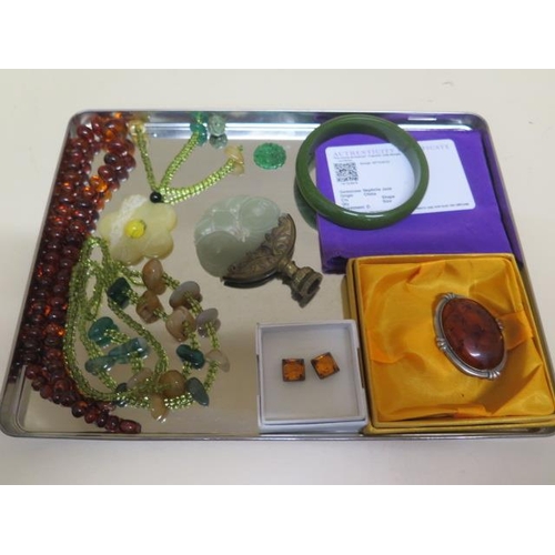 544 - A quantity of amber and nephrite jade jewellery including jade bangle, carved bead, amber brooch and... 