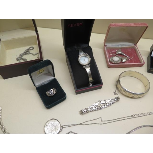 547 - A good selection of silver and white metal jewellery including bangles, chains, a Seksy watch,  Avon... 