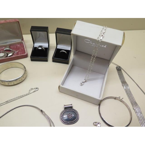 547 - A good selection of silver and white metal jewellery including bangles, chains, a Seksy watch,  Avon... 