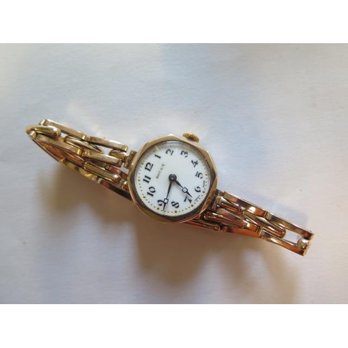 558 - A ladies 9ct gold manual wind watch with 9ct gold sprung bracelet with Rolex movement - boxed - work... 