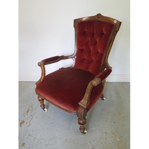 58 - A Victorian button back upholstered armchair on turned legs - Height 99cm x Width 71cm