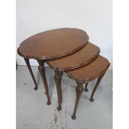 59 - A nest of three walnut tables with shaped tops - Height 53cm x Width 61cm