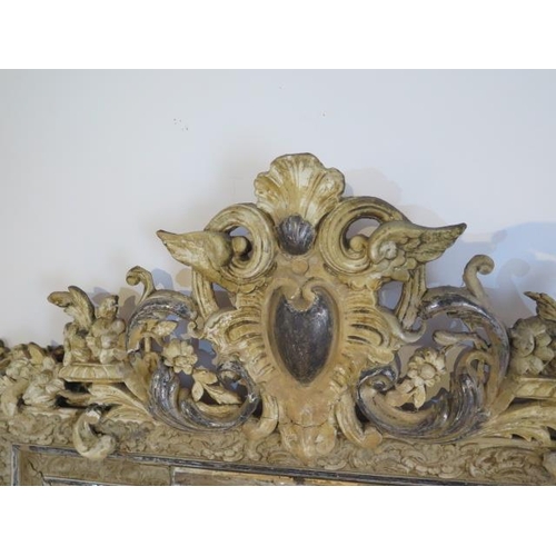 64 - An ornate decorative antique gesso cream and silvered mirror - Height 153cm x Width 91cm - some spot... 