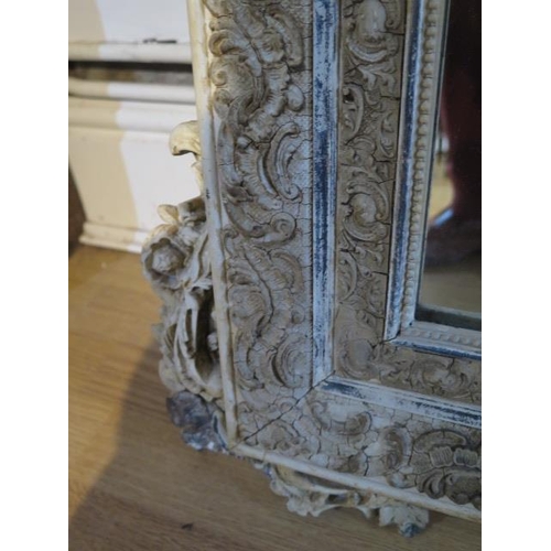 64 - An ornate decorative antique gesso cream and silvered mirror - Height 153cm x Width 91cm - some spot... 