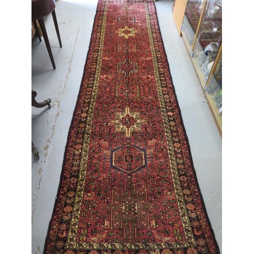 131 - A hand knotted woollen Meimeh rug - 3.23m x 1.10m - in good condition