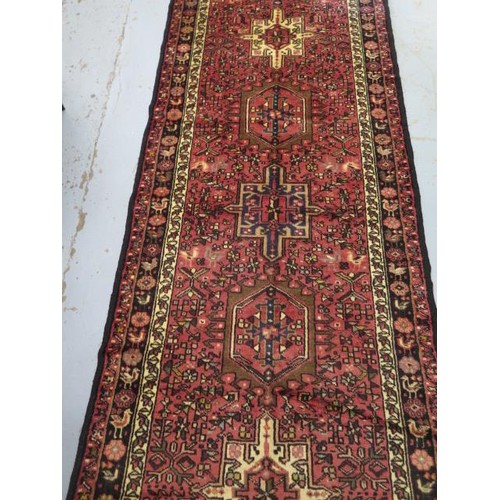 131 - A hand knotted woollen Meimeh rug - 3.23m x 1.10m - in good condition