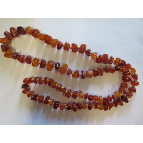 53 - An amber bead necklace - 90cm long and two Pandora silver rings, boxed - ring sizes K/L