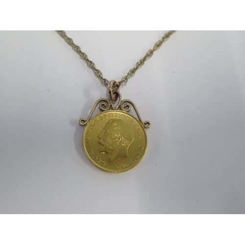 15 - A George V Sovereign dated 1912 with a fixed mount on a 9ct, 56cm chain - total weight approx 14.3 g... 