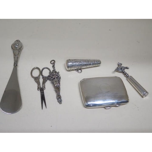 162 - A silver cigarette case, a silver cheroot holder case, a silver handle shoe horn, plated scissors an... 