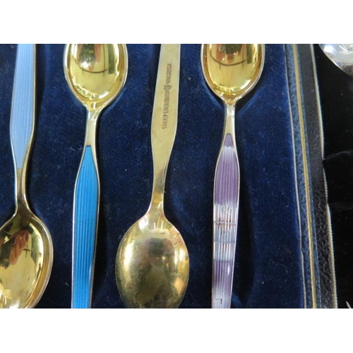 166 - Two boxed sets of enamelled silver spoons and a boxed set of silver coffee spoons - total weight app... 