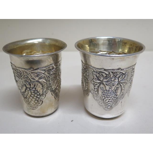 179 - A pair of graduating 925 silver grape pattern embossed stirrup cups - Largest 8cm tall - total appro... 