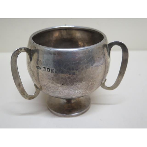 181 - A three handle silver cup with hammered finish London 1912/13 HHP - Henry Hodson Plante - approx wei... 