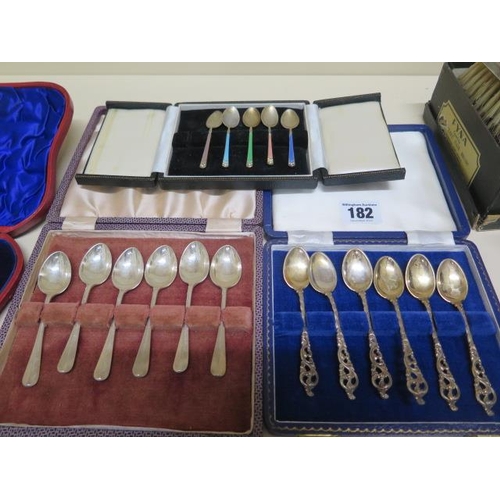 182 - Three boxed sets of silver spoons, a part set of enamel and silver spoons, a posy holder and a pair ... 